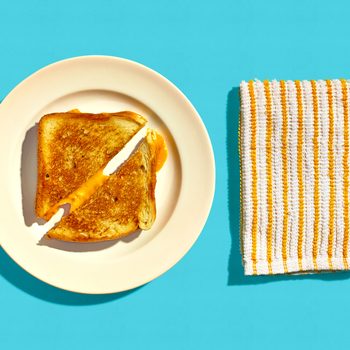 Grilled Cheese Sandwich on a Plate on a Blue Background