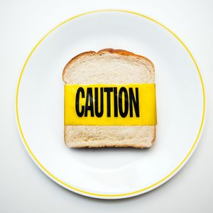 bread on plate with caution tape shot from above