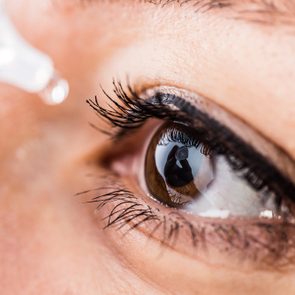 Bucharest, Romania - June 18,2016 : Macro image of a pipette releasing drops into brown eye