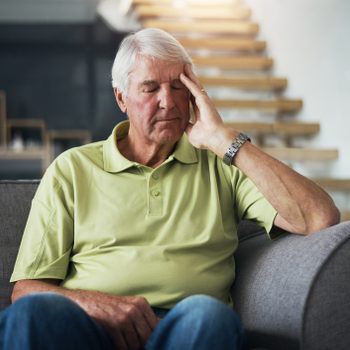 tired man sitting on couch