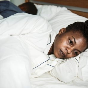 A woman wide awake in bed