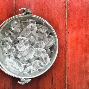 Ice cube in bucket on the wood table,with preset color.