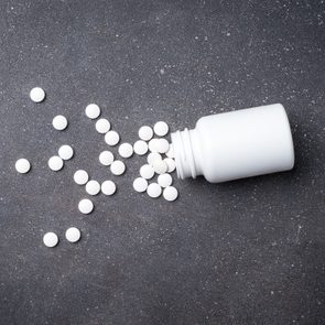 Pill bottle on dark background. Close up