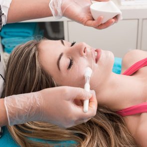 Woman having a facial massage and peeling in beauty salon