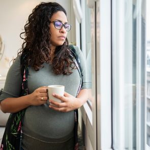 woman at home sad looking out window