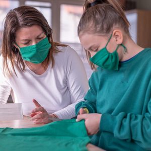 mother and daughter making face masks at home