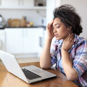 woman in pain while working at home