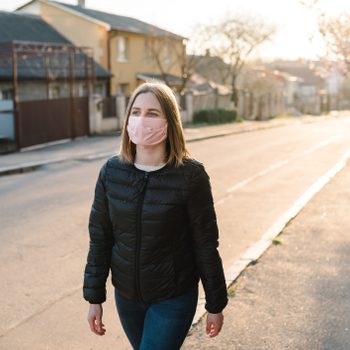 woman walking with mask on during coronavirus pandemic