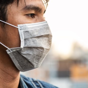 close up profile of man wearing a face mask