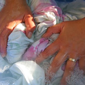 Woman hands washing clothes