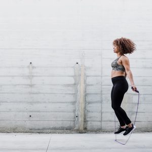 Woman Skipping Rope In Urban Area