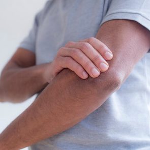 Man touching his elbow in pain