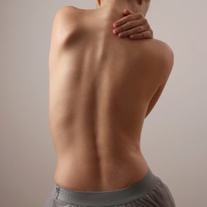 Woman with back pain, Scoliosis spine curve. Female body parts aesthetic, asymmetry