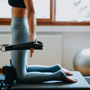 young sporty attractive woman practicing pilates yoga