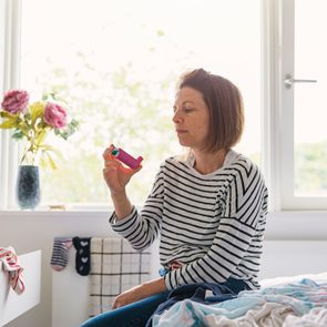 Woman with pink asthma inhaler