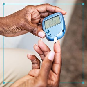 close up of hands checking blood sugar