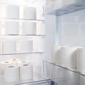 Open Refrigerator With Large Amount Of Toilet Paper Rolls Inside Humorous Storage Concept